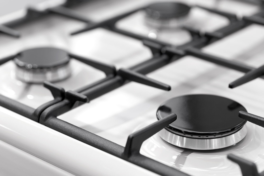 Close-up image of a modern gas stove with clean burners, emphasizing the maintenance services offered by FixEmApplianceRepair in Oakland.